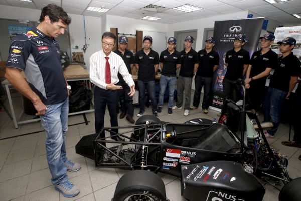 Mark Webber takes a look at a car during his visit to the launch of the Infiniti Performance Engineering Academy at Nanyang University of Singapore.